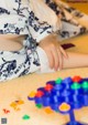 A little girl sitting on the floor playing with a game.