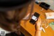 A woman sitting at a table using a cell phone.